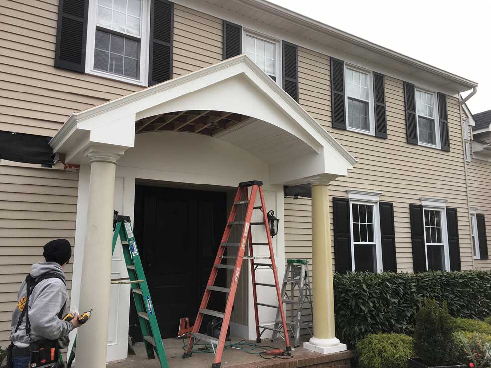 Local contractors install shiplap inside this new porch roof
